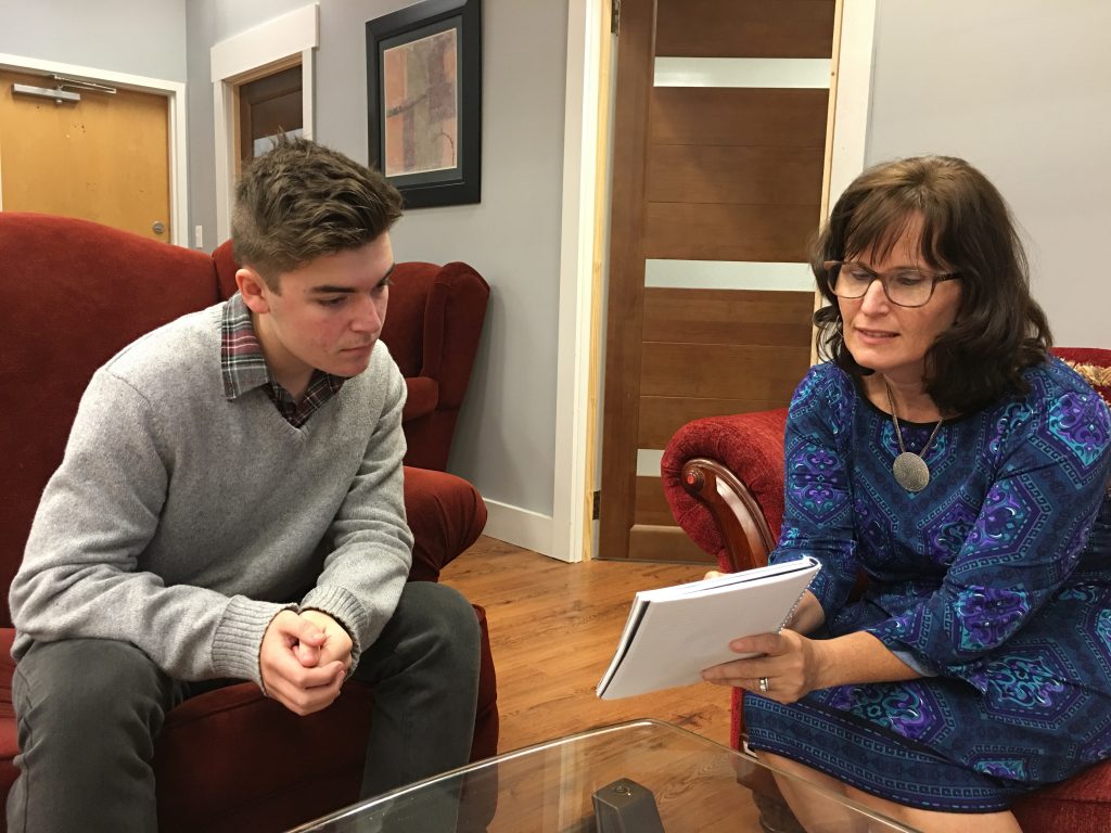 Laurie speaking with a teen