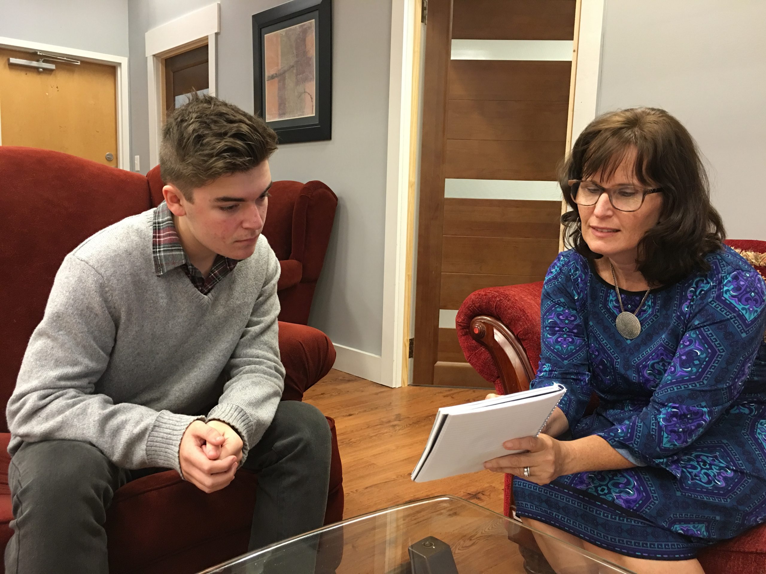 Laurie speaking with a teen