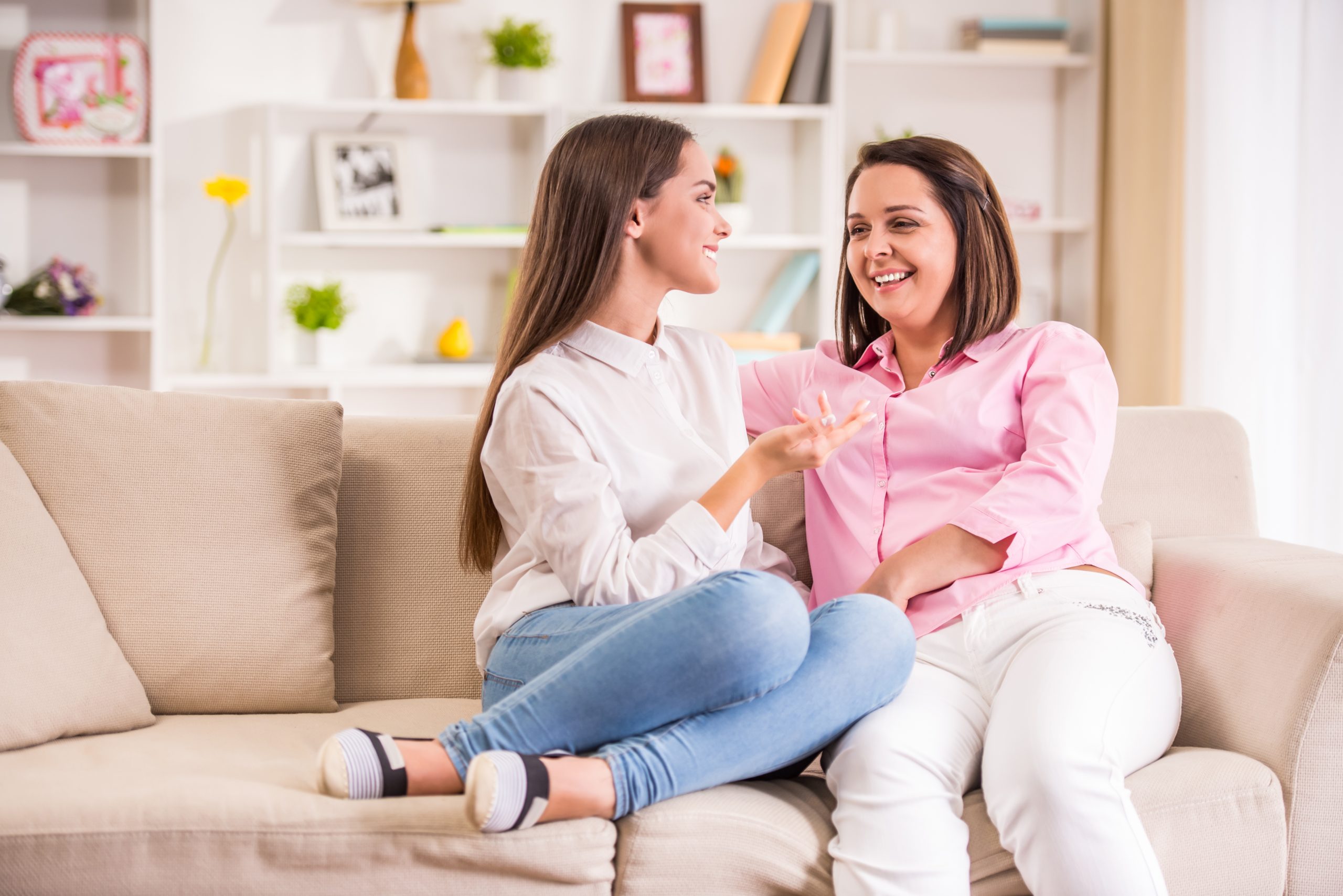 Mother and daughter talking on the couch