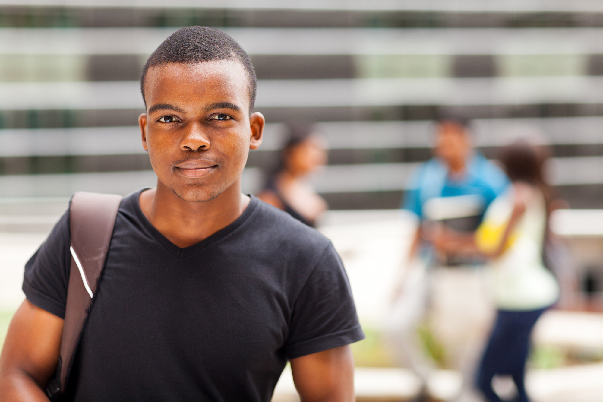 african college boy standing outdoors