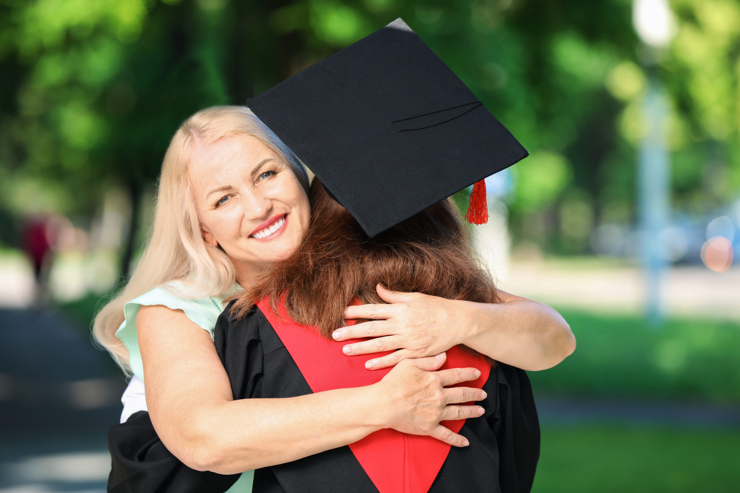 Happy mother greeting her daughter on graduation day