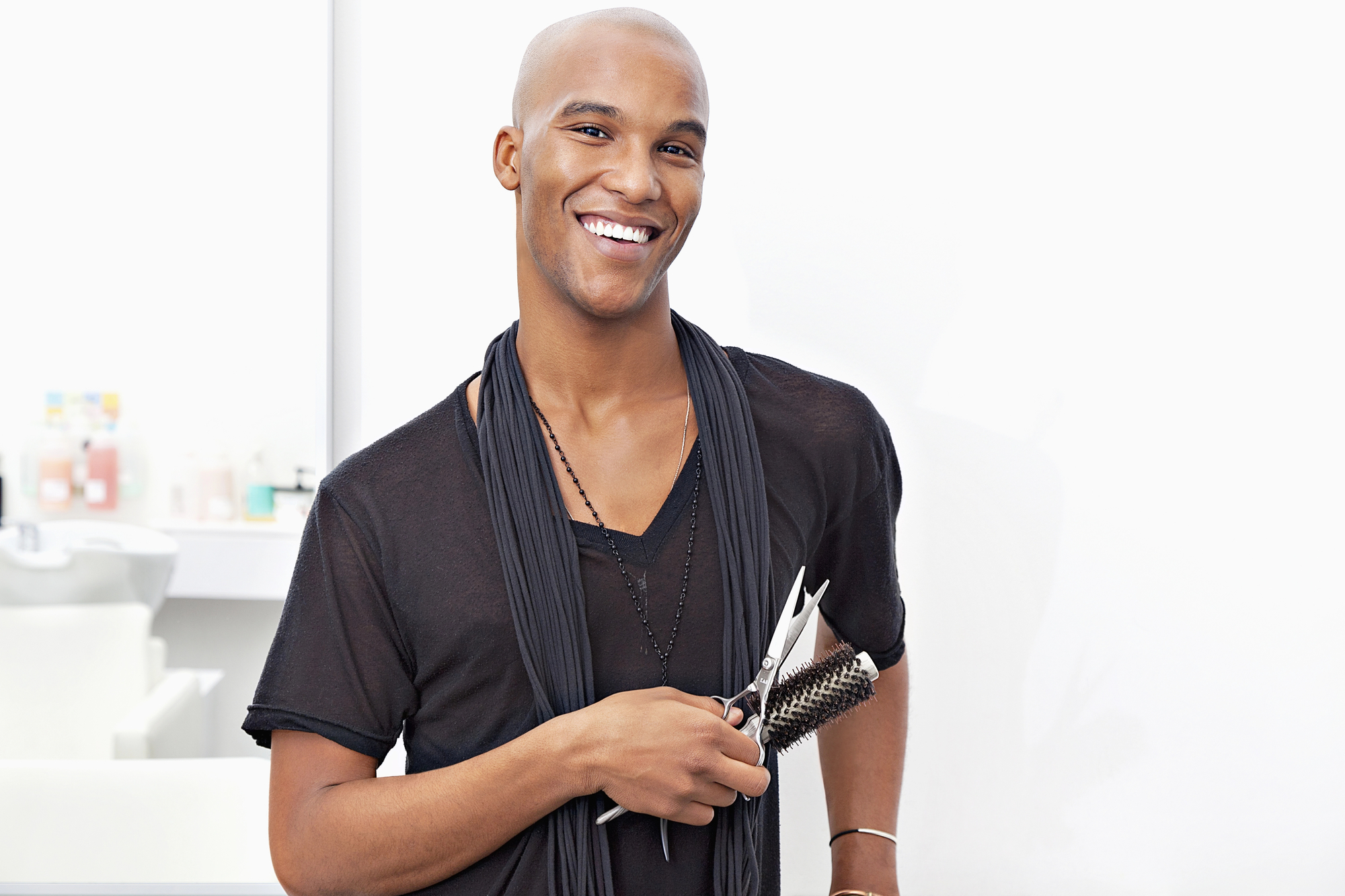 Male hair stylist holding a brush.