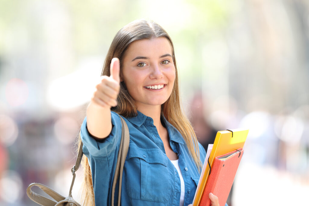 teen girl showing thumbs up