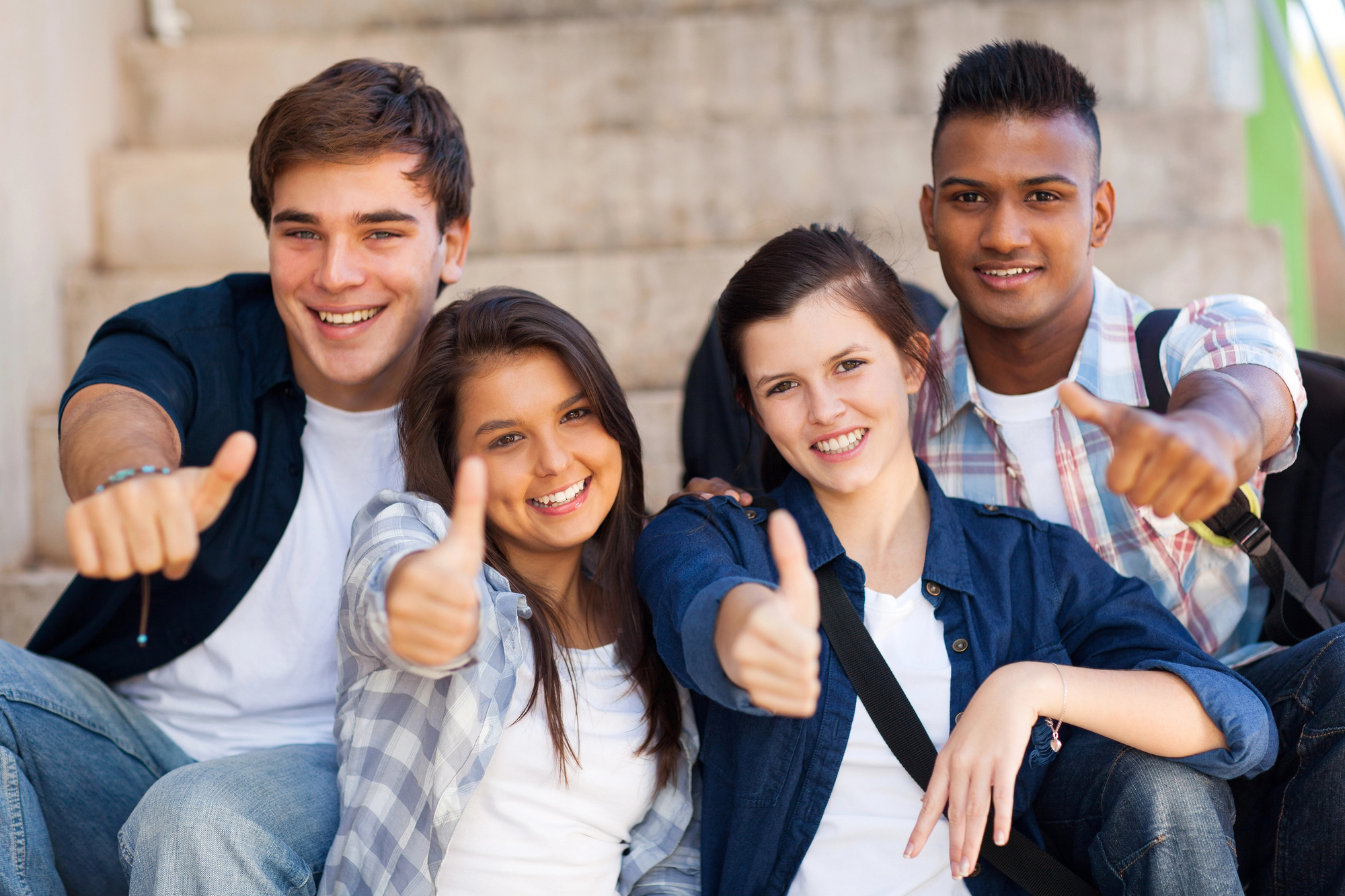 Group of teens showing thumbs up