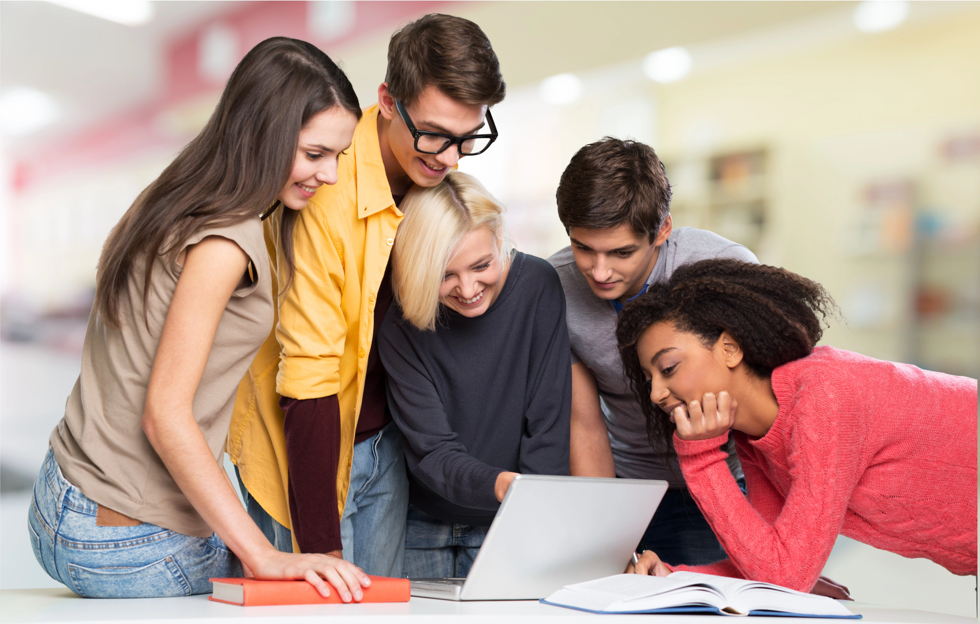 Group of teens looking at computer