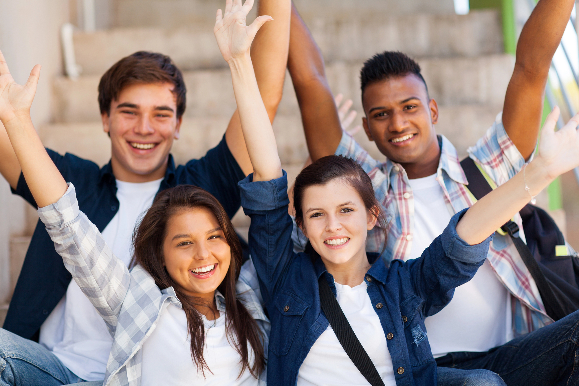 teens together with hands raised