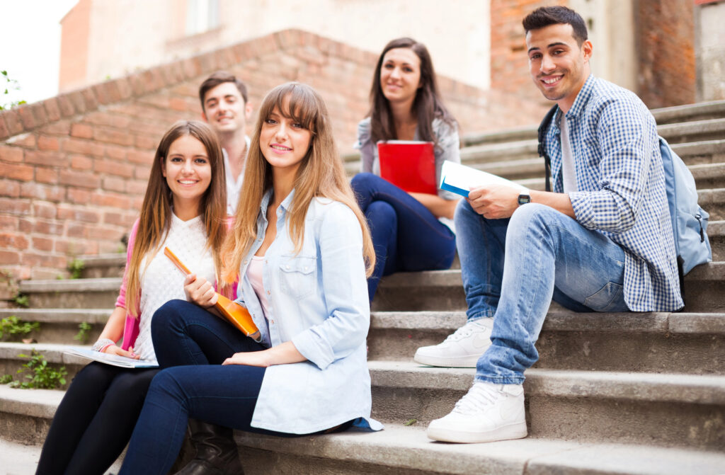 Teenage kids sitting together on steps.
