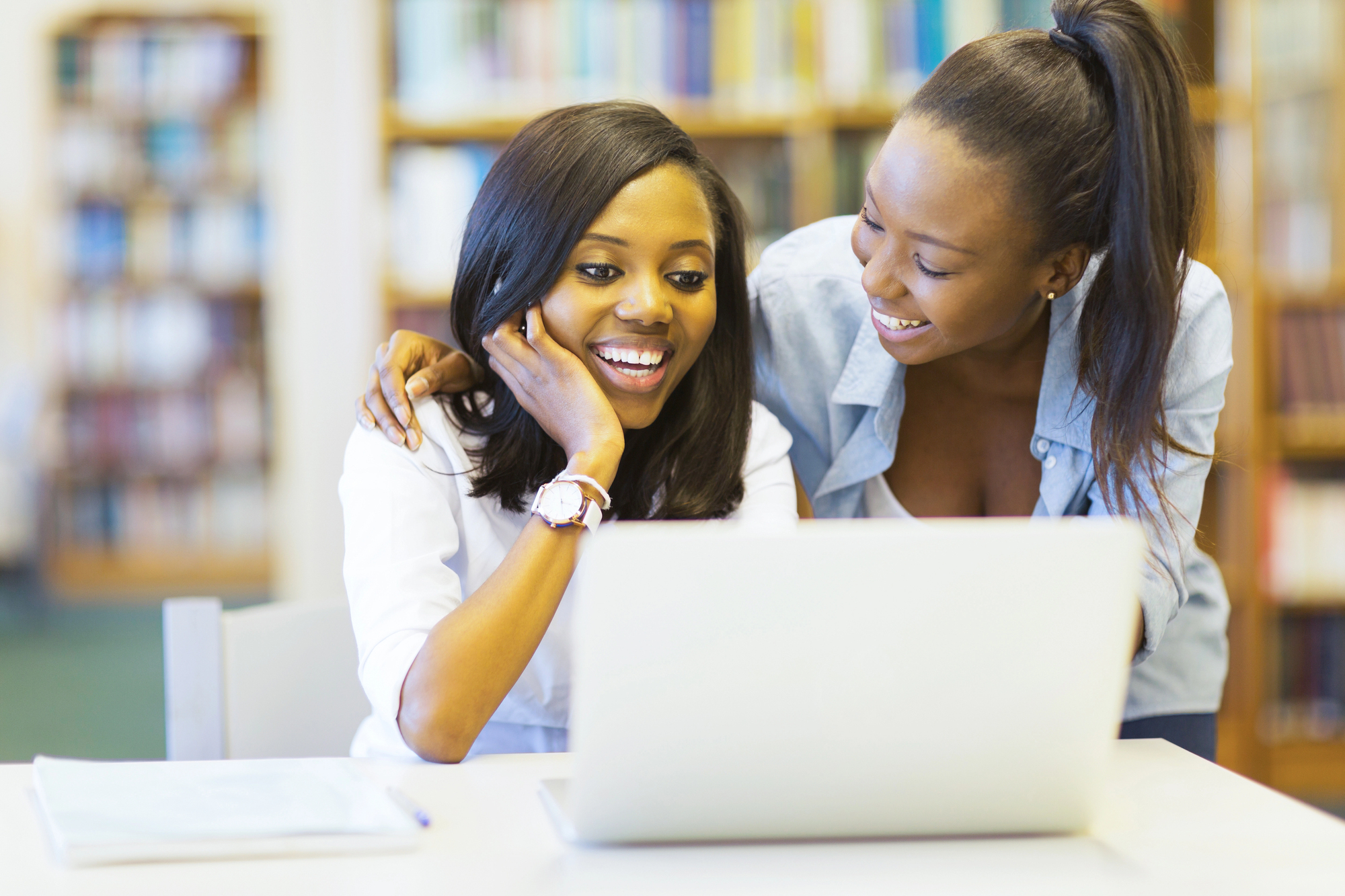 Mother and daughter looking at a computer screen