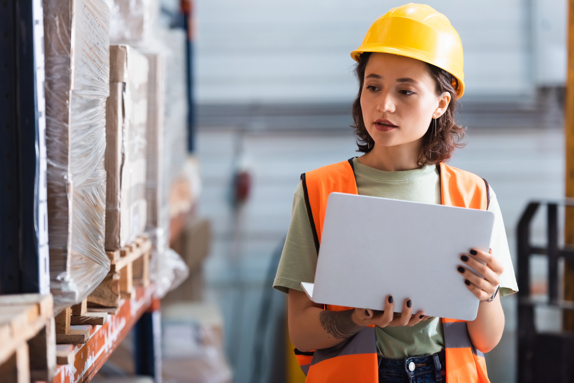 Woman with a hardhat working in a trade.