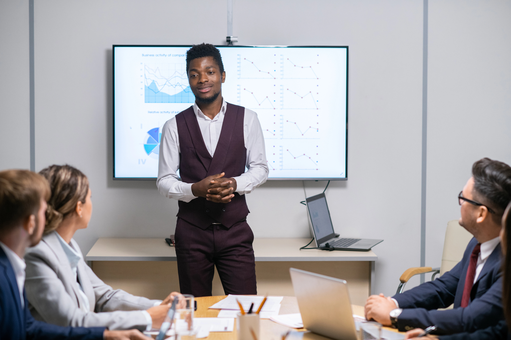 Young professional giving a presentation in a conference room, representing the workplace skills and career fit teens need for future success.