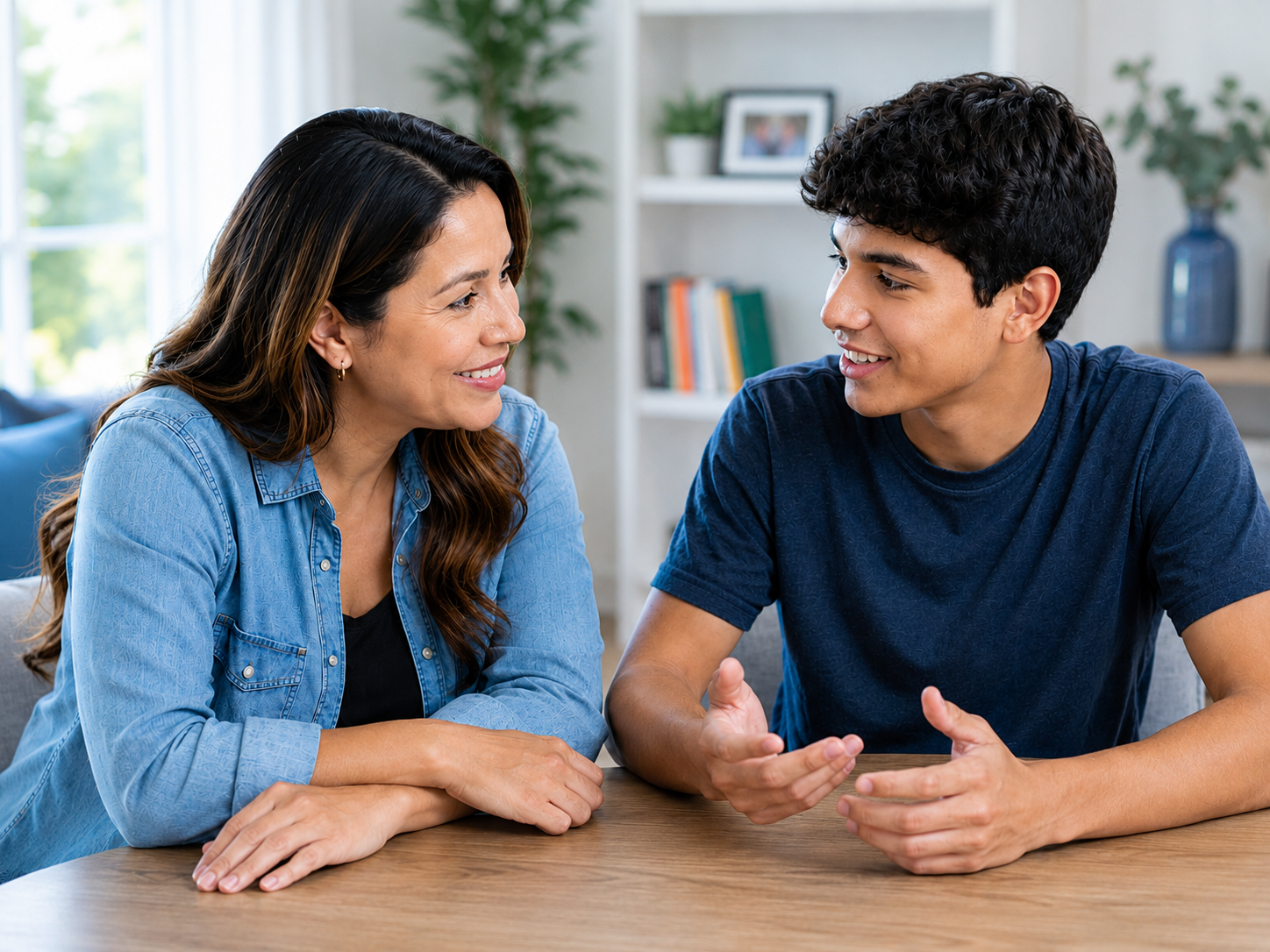 Mother listening as her teenage son talks about college and future plans at home.